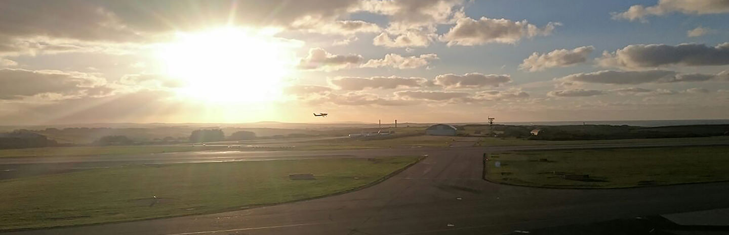 Cessna 152 taking off at sunset at Cornwall Airport Newquay