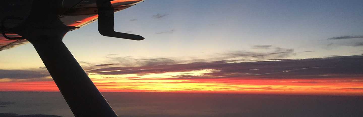 Cessna 152 taking off at sunset at Cornwall Airport Newquay